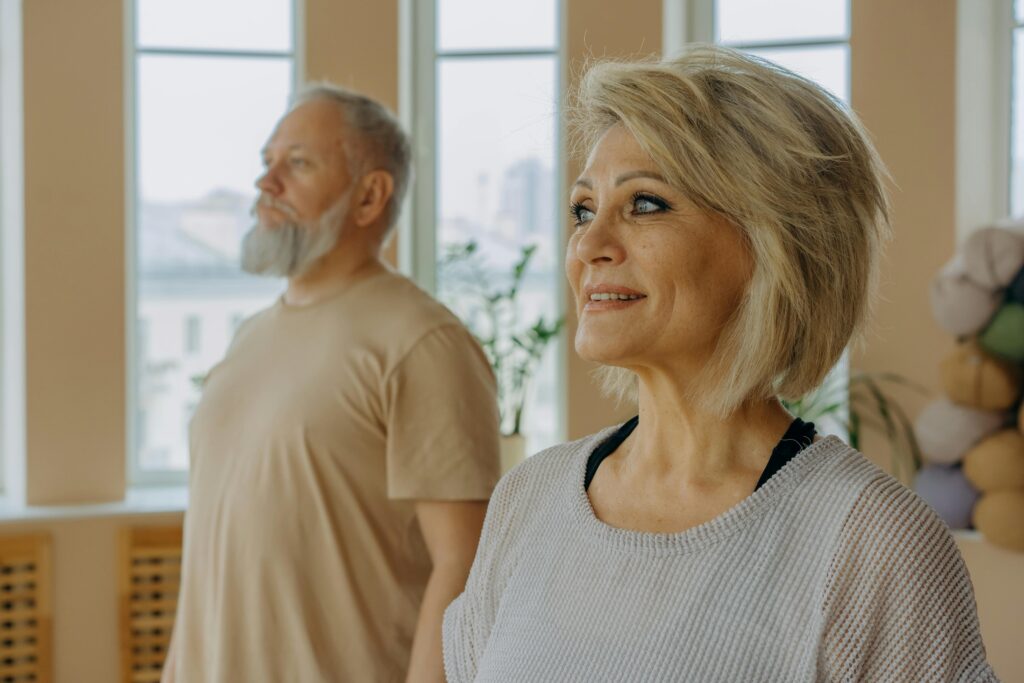 Senior couple at a wellness studio enjoying yoga and relaxation indoors.